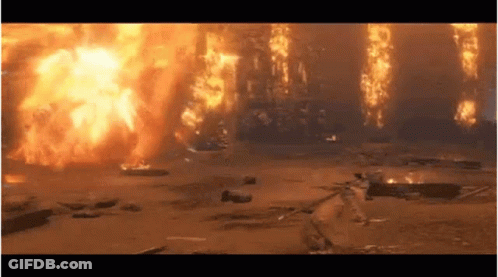 A Large Explosion Is Taking Place In A Field With A Lot Of Fire Coming Out Of It . GIF