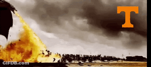 A Large Fire Is Being Thrown In The Air With The Letter T Above It GIF