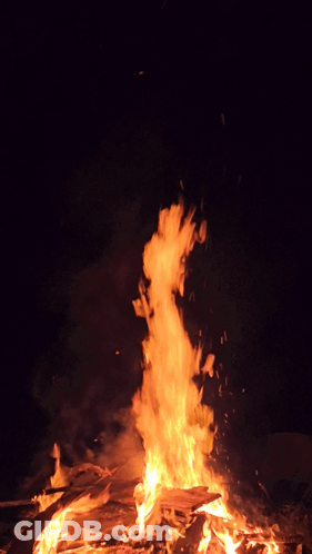 A Large Fire Is Burning In The Dark With Lots Of Flames GIF