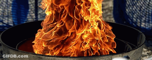 A Large Fire Is Coming Out Of A Metal Container GIF