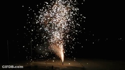 A Large Fireworks Display Is Going Off In The Night Sky GIF