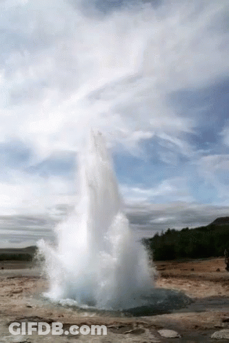 A Large Geyser Is Erupting In The Middle Of A Desert GIF