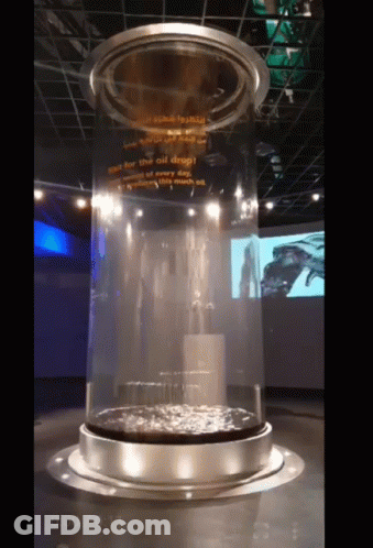 A Large Glass Cylinder With A Sign That Says " See For The Oil Deep " GIF