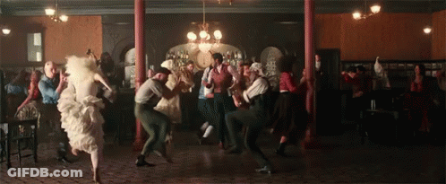 A Large Group Of People Are Dancing In A Room GIF
