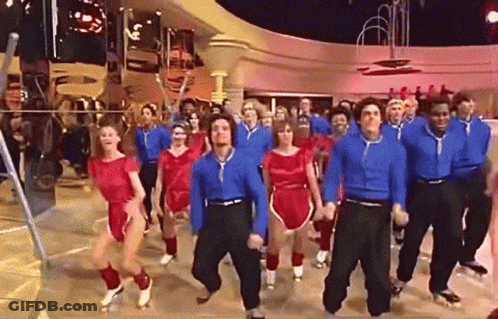 A Large Group Of People Are Dancing In A Room GIF