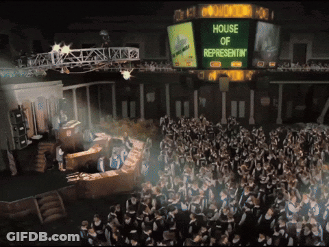 A Large Group Of People Are Gathered In Front Of A Large Screen That Says House Of Representatives GIF