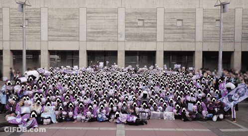A Large Group Of People Are Posing For A Picture In Front Of A Large Building GIF