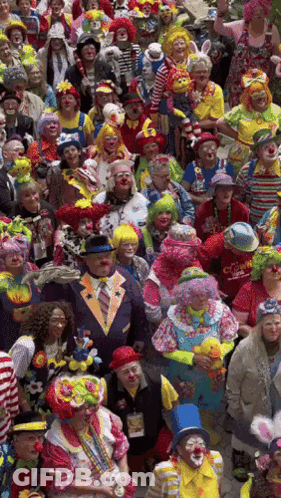 A Large Group Of People Dressed In Clown Costumes Including A Man Wearing A Red Shirt That Says ' Clown ' GIF
