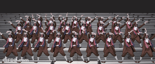 A Large Group Of People Wearing Sunglasses Are Standing In A Row GIF