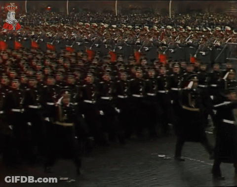 A Large Group Of Soldiers March In A Parade With The Number 7 In The Middle GIF