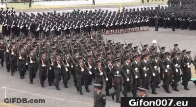 A Large Group Of Soldiers Marching In A Parade With Guns In Their Hands . GIF