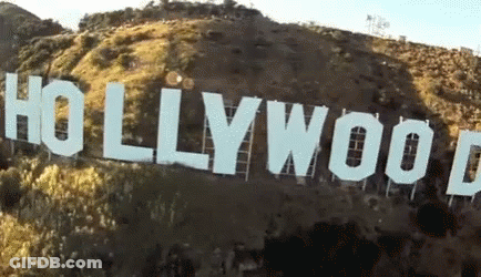 A Large Hollywood Sign Is Sitting On Top Of A Hill GIF