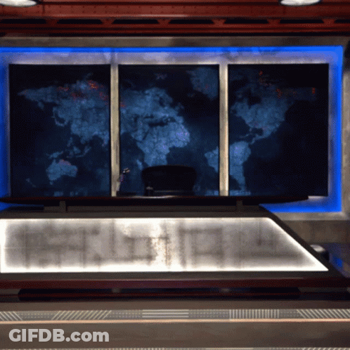 A Large Map Of The World Hangs On A Wall Above A Desk GIF