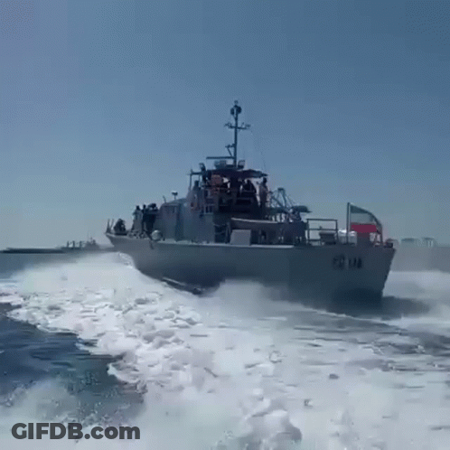 A Large Military Ship Is Going Through The Ocean GIF