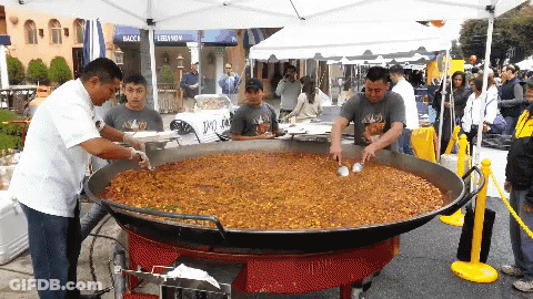 A Large Pan Of Food Is Being Cooked In Front Of A Bacca Lebanon Tent GIF