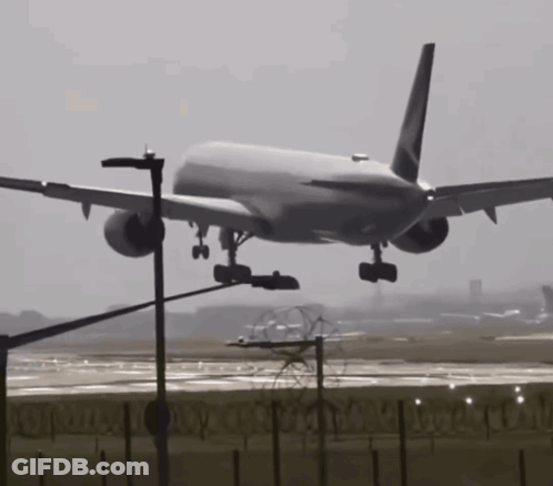 A Large Passenger Jet Is Taking Off From A Runway GIF