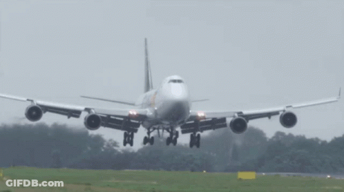 A Large Passenger Jet Is Taking Off From A Runway GIF