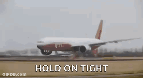 A Large Passenger Jet Is Taking Off From An Airport Runway With The Words `` Hold On Tight '' Written Above It . GIF