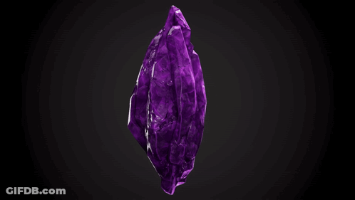 A Large Purple Crystal On A Black Background . GIF