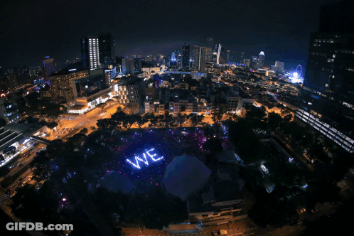 A Large Purple Ready Sign Is Lit Up In A City GIF