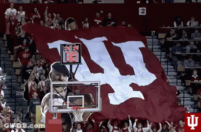 A Large Red And White Flag With The Letters Ii On It GIF