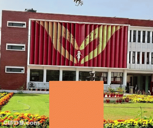 A Large Red Building With A Statue Of A Woman On The Front GIF