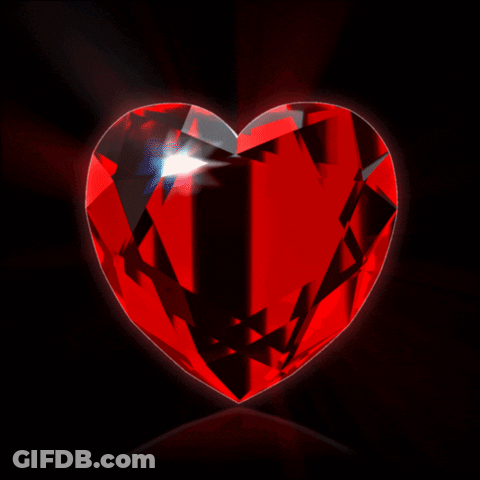 A Large Red Heart Shaped Diamond With A Black Background GIF