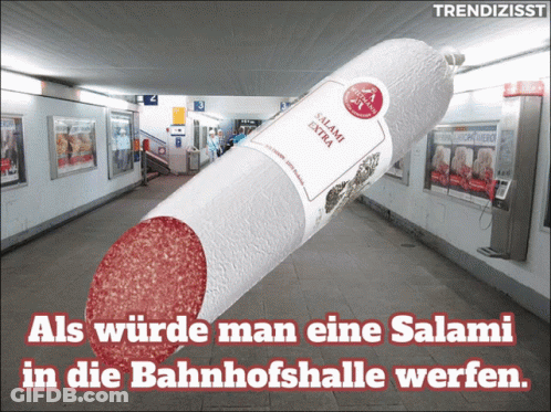 A Large Salami In A Subway With The Words " Als Wurde Man Eine Salami In Die Bahnhofshalle Werfen " Below It GIF