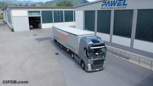 A Large Truck Is Parked In Front Of A Building That Says Pawel GIF