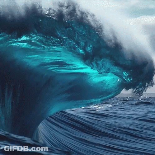 Large Wave Breaking In Ocean Resembling Shark GIF