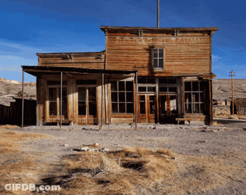 A Large Wooden Building With A Blue Sky In The Background GIF