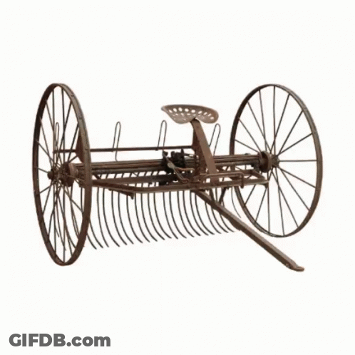 A Large Yellow Bulldozer With Chains On The Wheels GIF