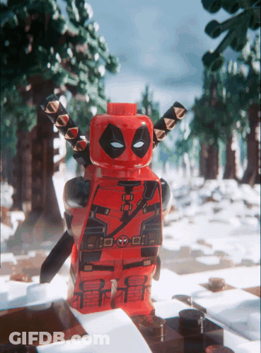 A Lego Deadpool Figure Stands In The Snow GIF
