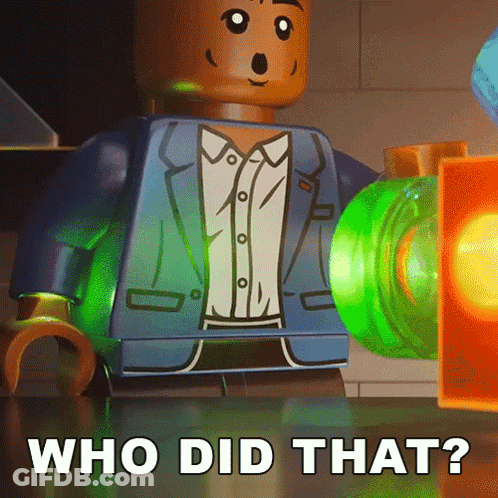 A Lego Man In A Suit Is Standing Next To A Green Object That Says Who Did That On It GIF