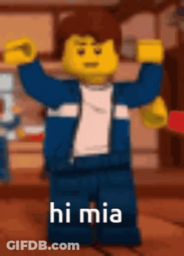 A Lego Man Is Standing With His Arms In The Air And Says Hi Mia . GIF