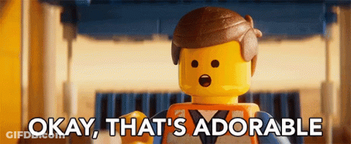 A Lego Man Says Okay That 'S Adorable In Front Of A Building GIF