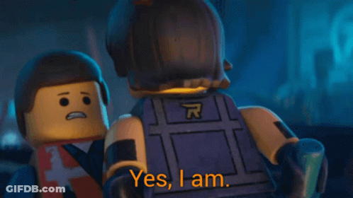 A Lego Man Says " Yes I Am " While Wearing A Vest With The Letter A On It GIF