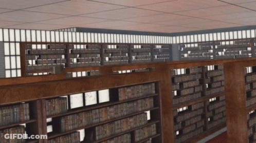A Library With Lots Of Books On Shelves And A Balcony GIF