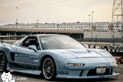 A Light Blue Sports Car With Rays Stickers On The Front GIF