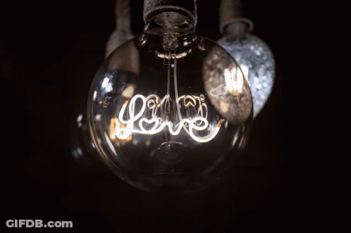 A Light Bulb That Has The Word Love Written On It GIF
