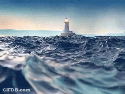 A Lighthouse In The Middle Of The Ocean With Waves Crashing Around It GIF
