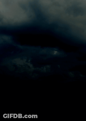 A Lightning Bolt Is Visible In The Dark Sky GIF