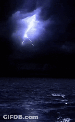 A Lightning Bolt Is Visible Over The Ocean GIF