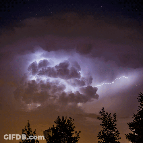 A Lightning Bolt Strikes A Cloud In The Sky GIF