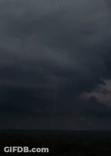 A Lightning Bolt Strikes The Ground In The Middle Of The Field GIF
