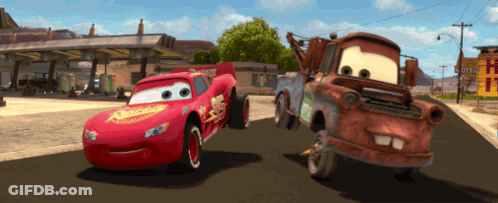 A Lightning Mcqueen And A Tow Truck From Cars Are Driving Down A Road GIF