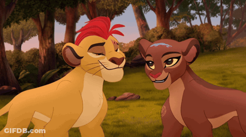 A Lion And A Lioness Are Standing Next To Each Other GIF