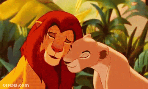 A Lion And A Lioness From The Lion King Are Hugging Each Other In The Jungle . GIF