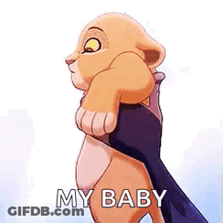 A Lion Cub From The Lion King Is Holding A Person 'S Hand . GIF