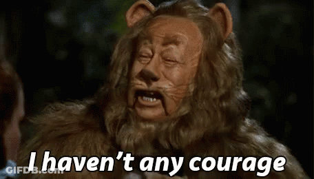 A Lion From The Wizard Of Oz Is Talking To A Woman And Saying `` I Haven 'T Any Courage '' . GIF